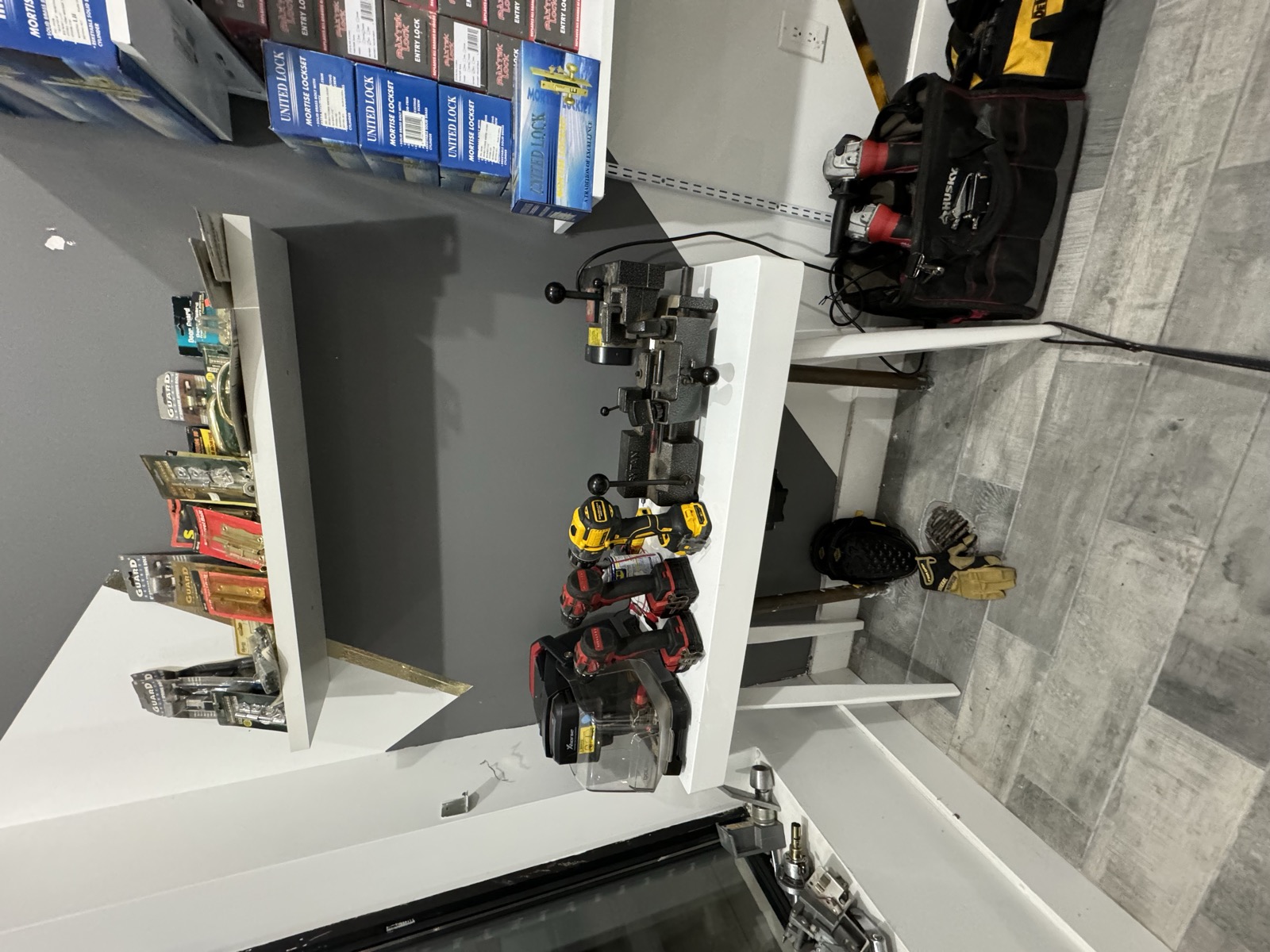 Key-cutting bench with duplicators and drills at the President St shop
