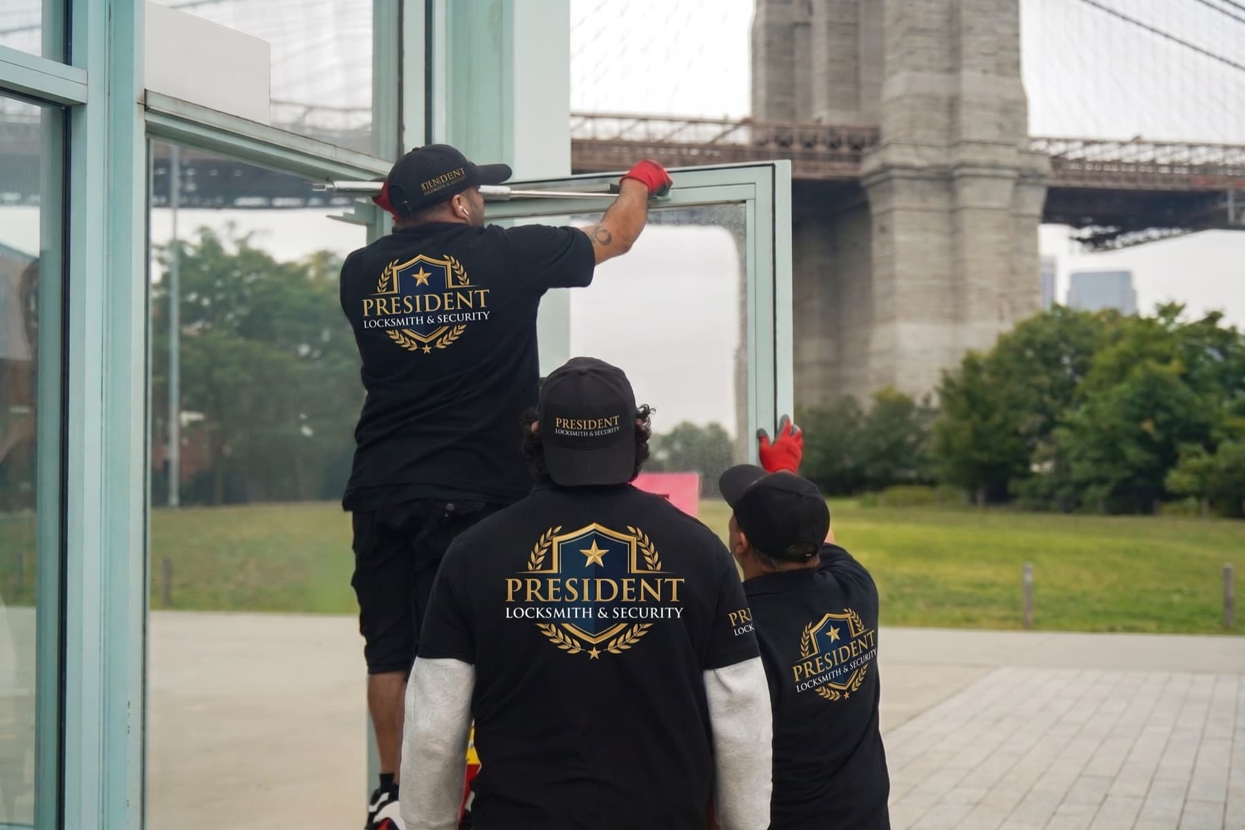 President Locksmith & Security technicians working on a commercial glass door by the Brooklyn Bridge