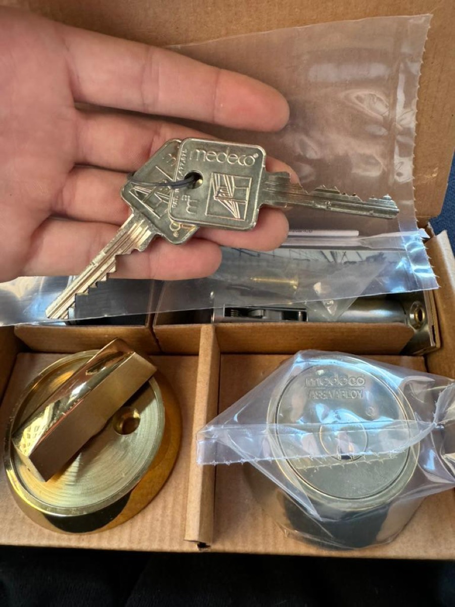 Medeco high-security cylinders and restricted keys, unboxed on site